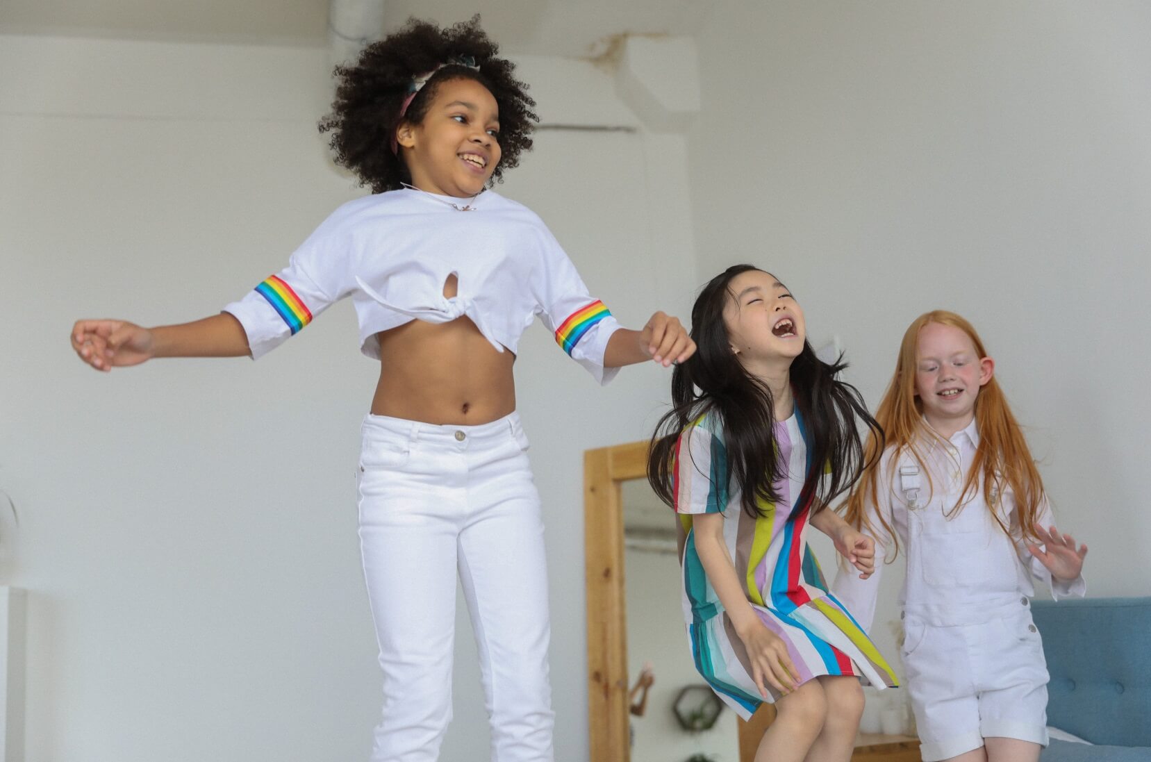 3 Children jumping in the air and smiling