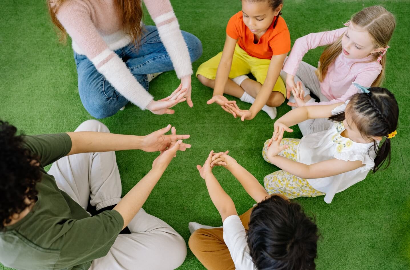 Children sitting in a circle facing eachother